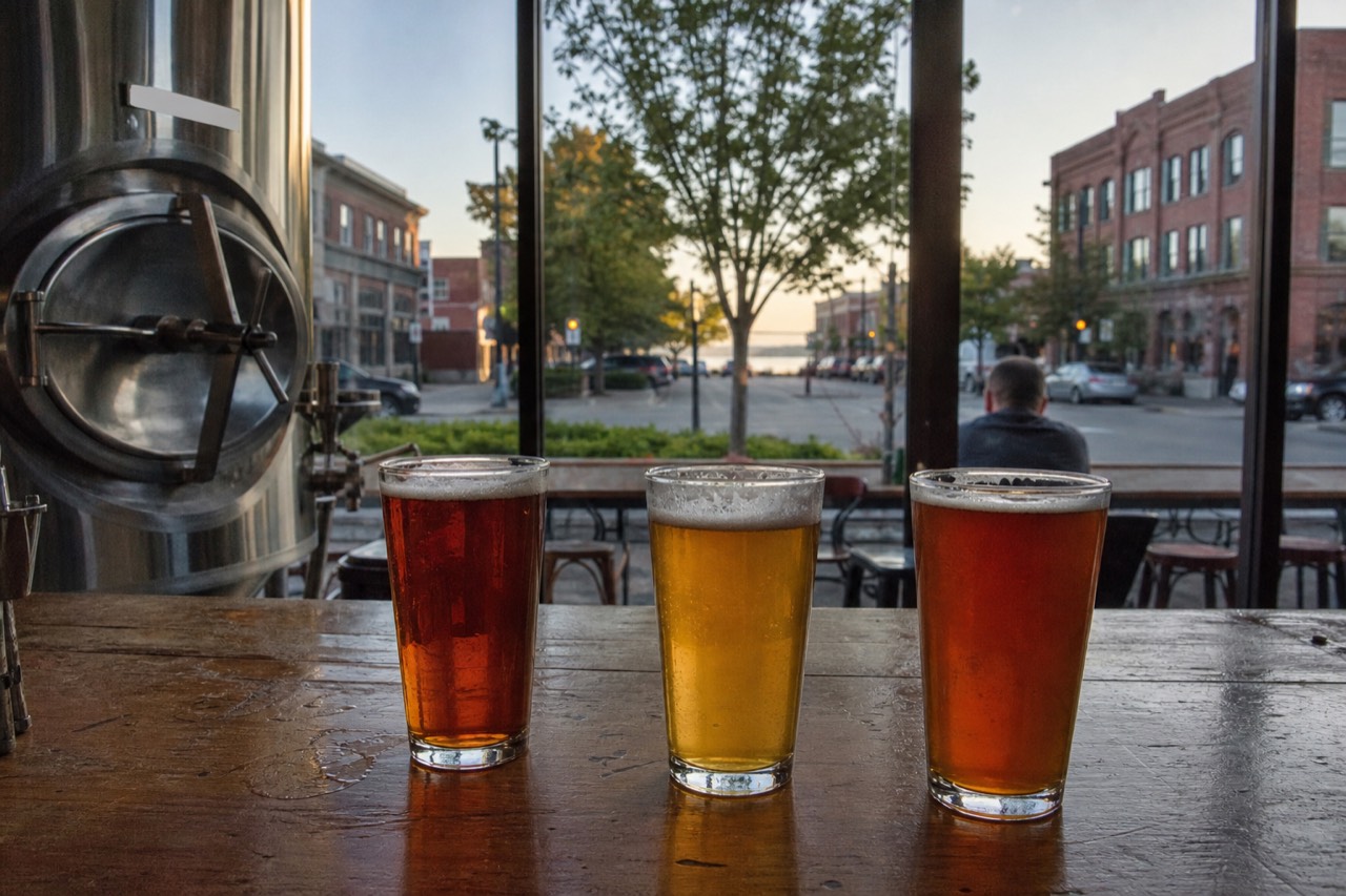 Pints of craft beer on a wooden bar in a Traverse City taproom