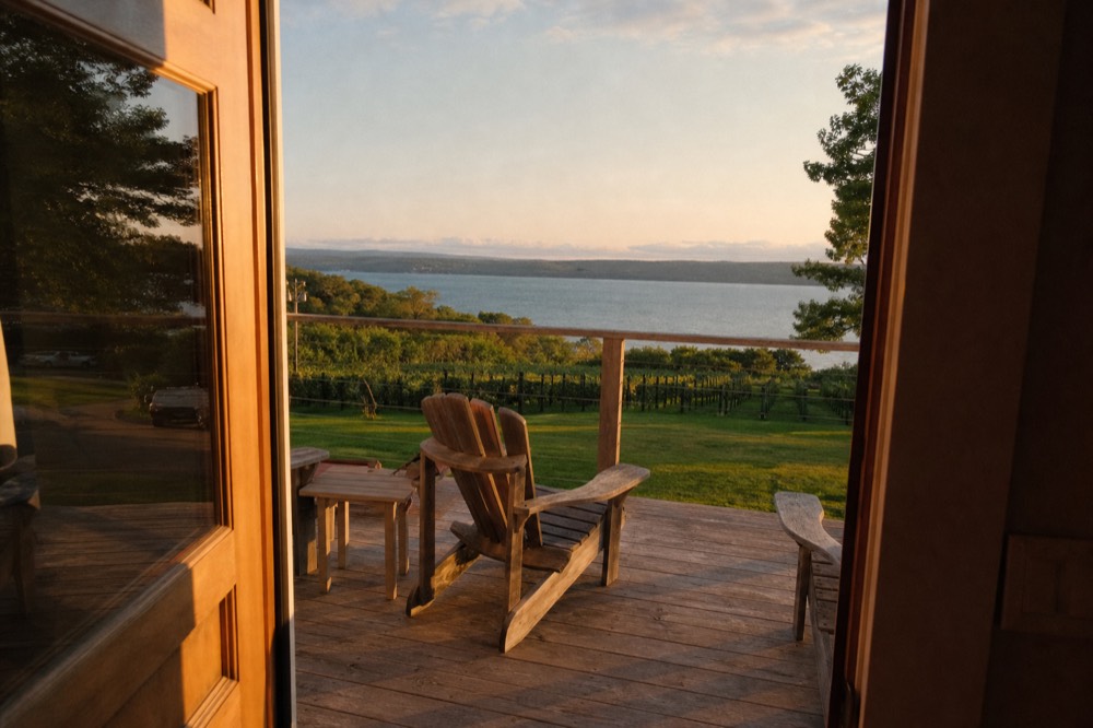 A quiet tasting room deck at golden hour above a northern Michigan bay