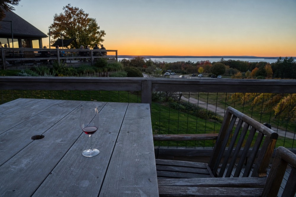 Sunset over Grand Traverse Bay seen from a vineyard deck