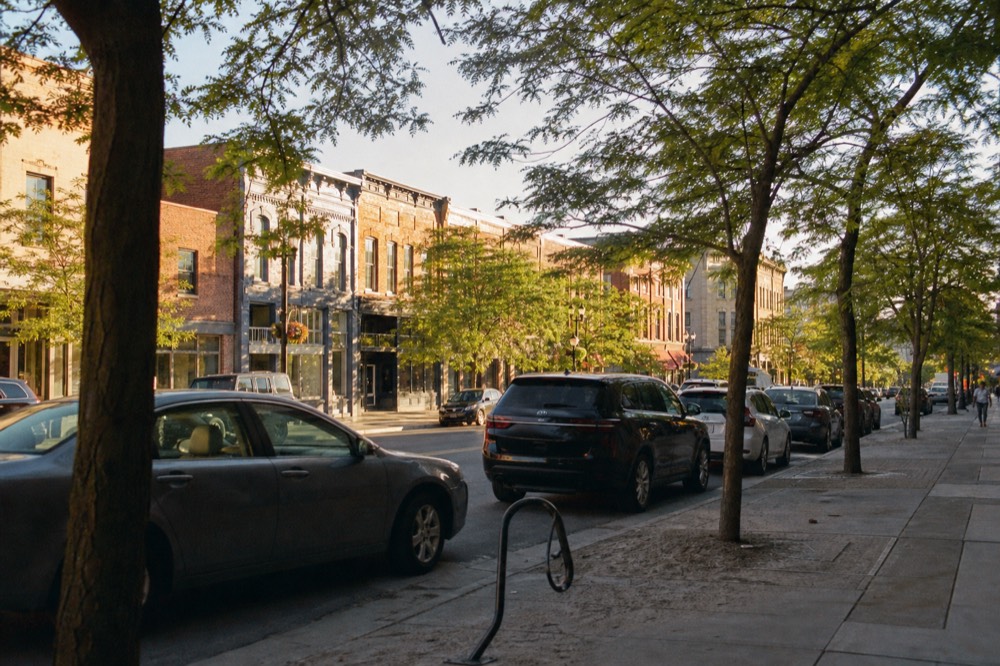 A downtown street with storefronts and trees in Traverse City