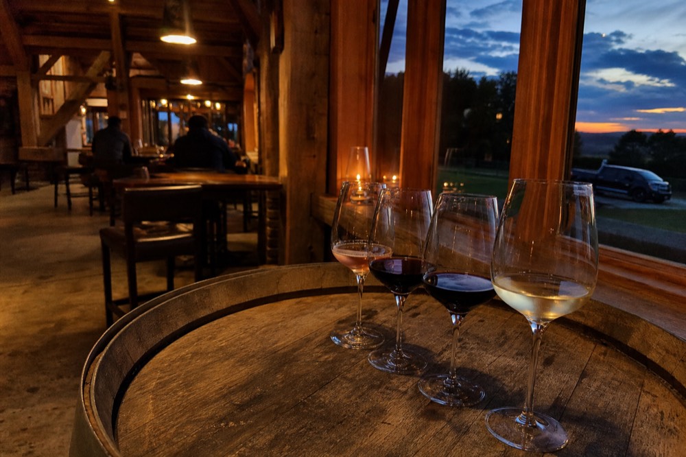 An evening tasting flight on a barrel top with warm low light through a window