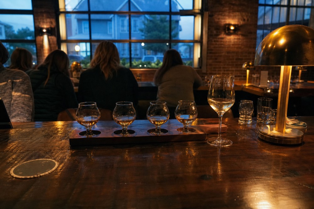 Small glasses of spirits and wine lined on a bar in the evening