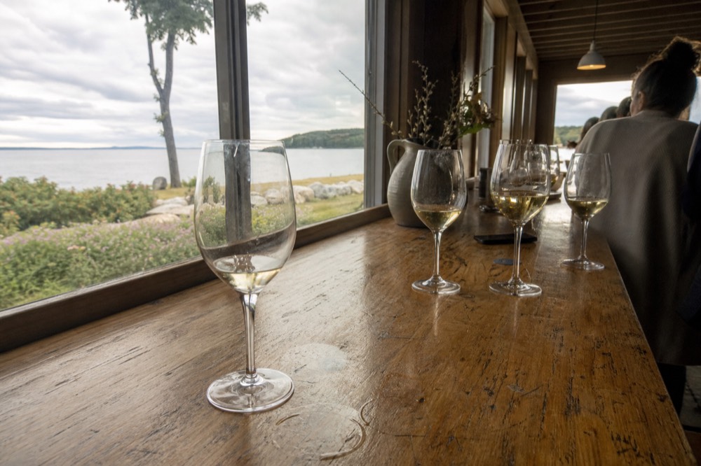 A tasting flight of white wines on a winery bar counter