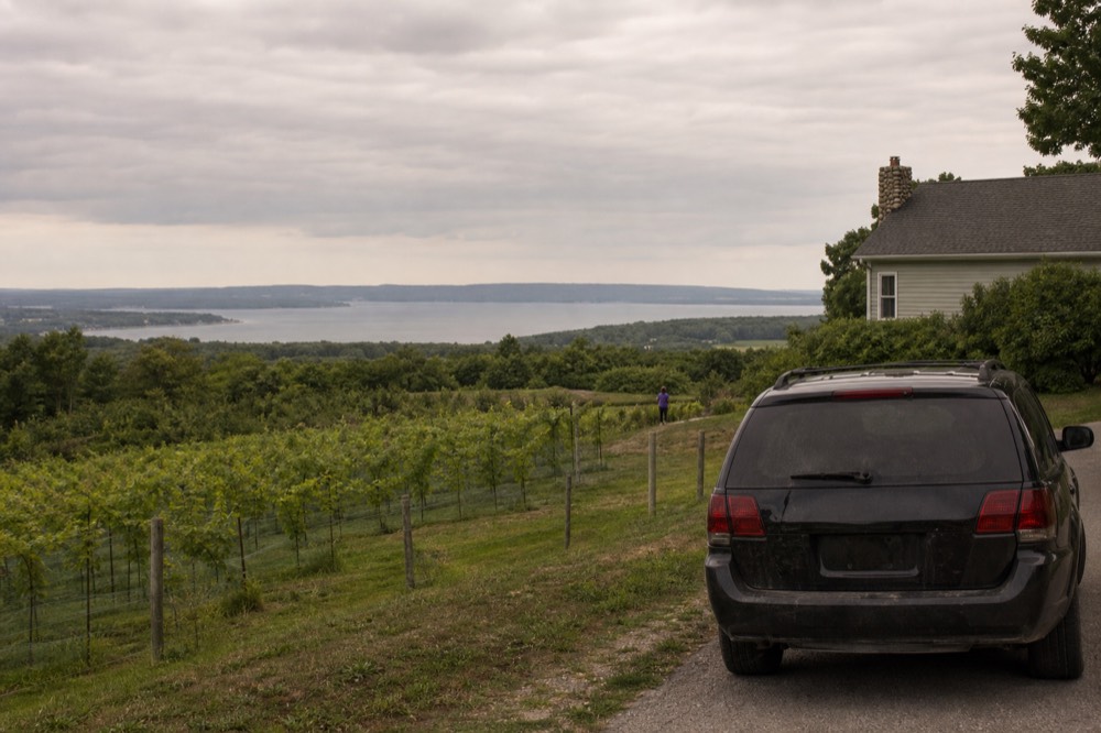 SUV parked at a winery overlook on a narrow peninsula road